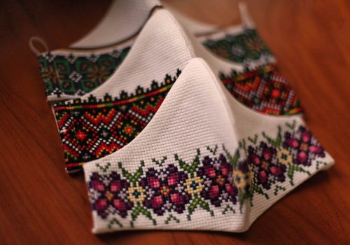 Purple and green hand embroidered face mask with Ukrainian design