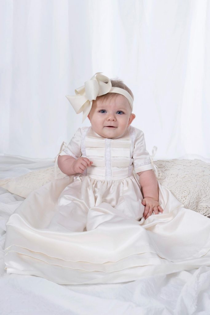 Baby girl in pleated heirloom silk baptismal christening gown