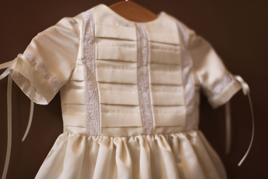 Silk ivory pleated christening gown with lace and ribbons