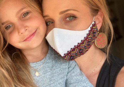 Mother daughter in embroidered face masks and stella and tide catholic religious jewelry