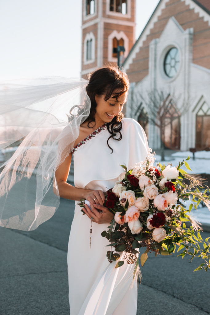 Bride in Ukrainian Embroidered dress holding DIY wedding bouquet